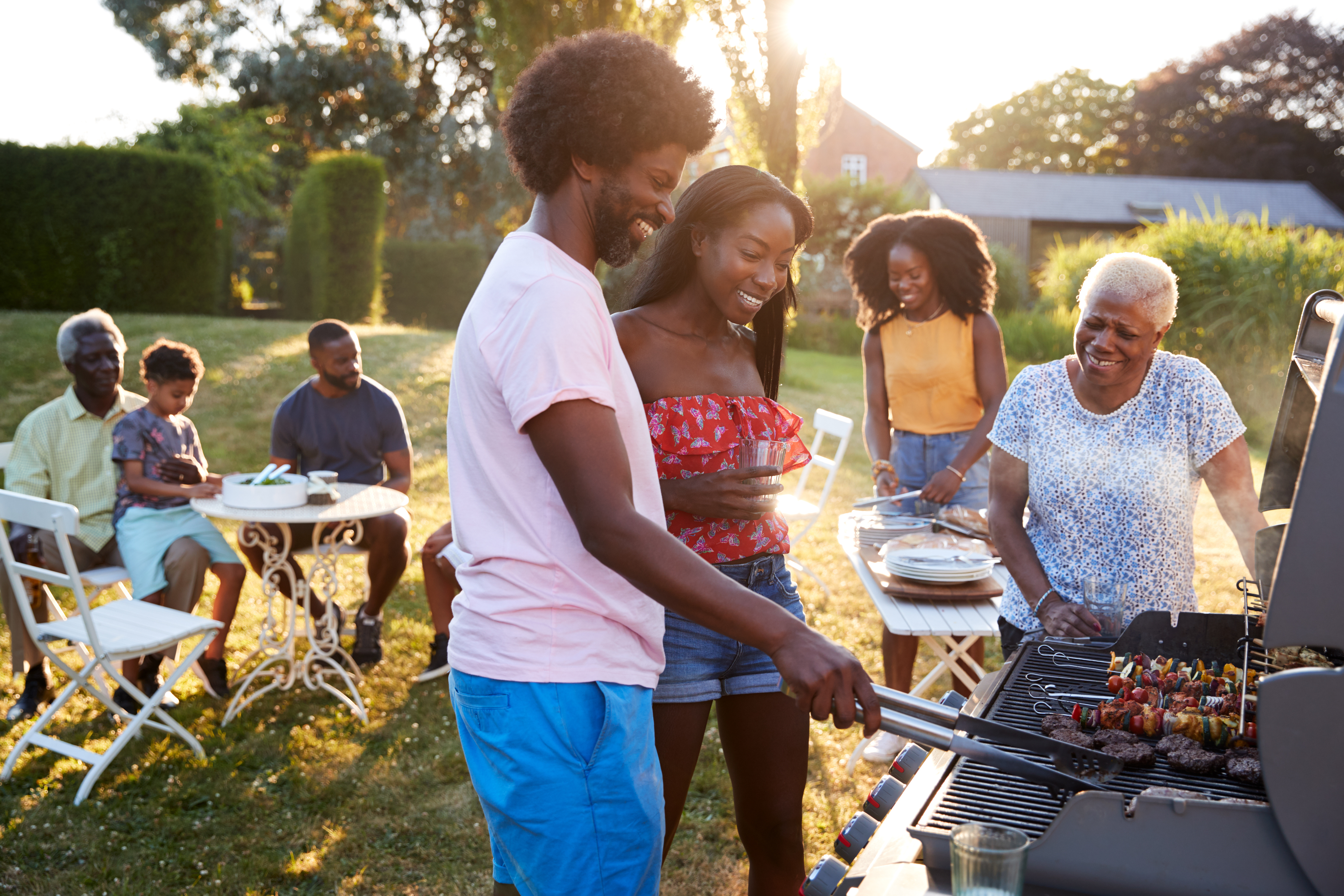 Family grilling food outdoors