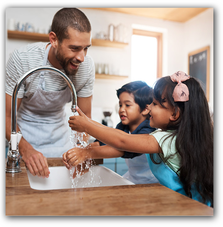 Father teaching children to wash hands correctly