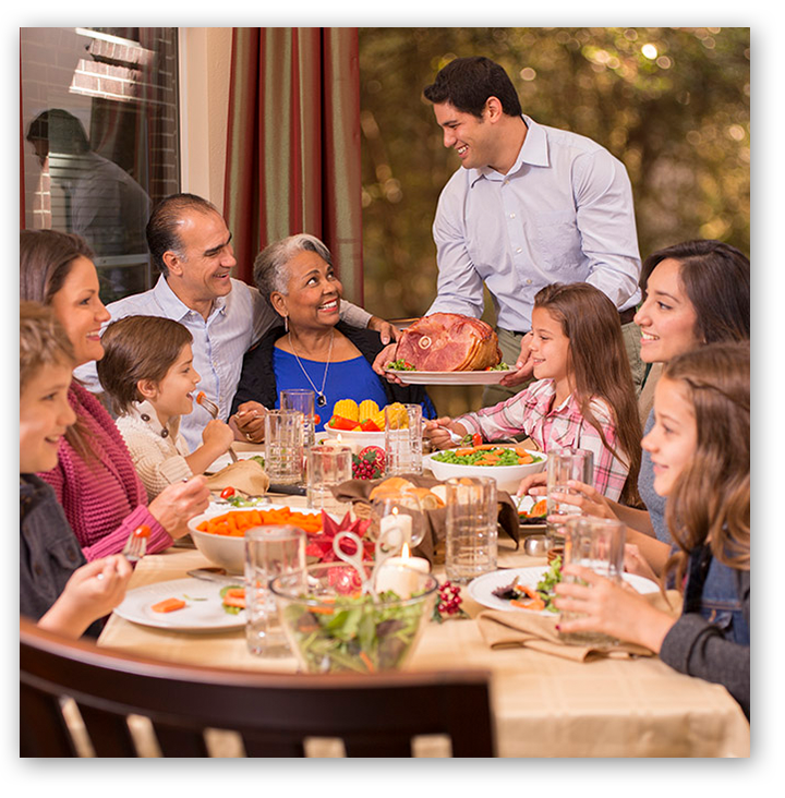 Family having ham for dinner
