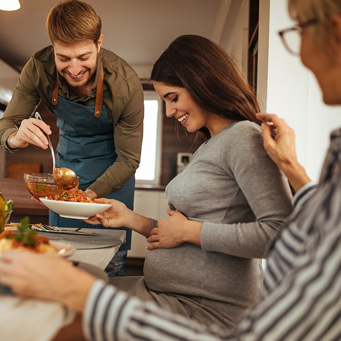 Pregnant woman being served a meal