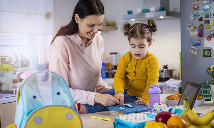 Mother packing a lunch for her daughter