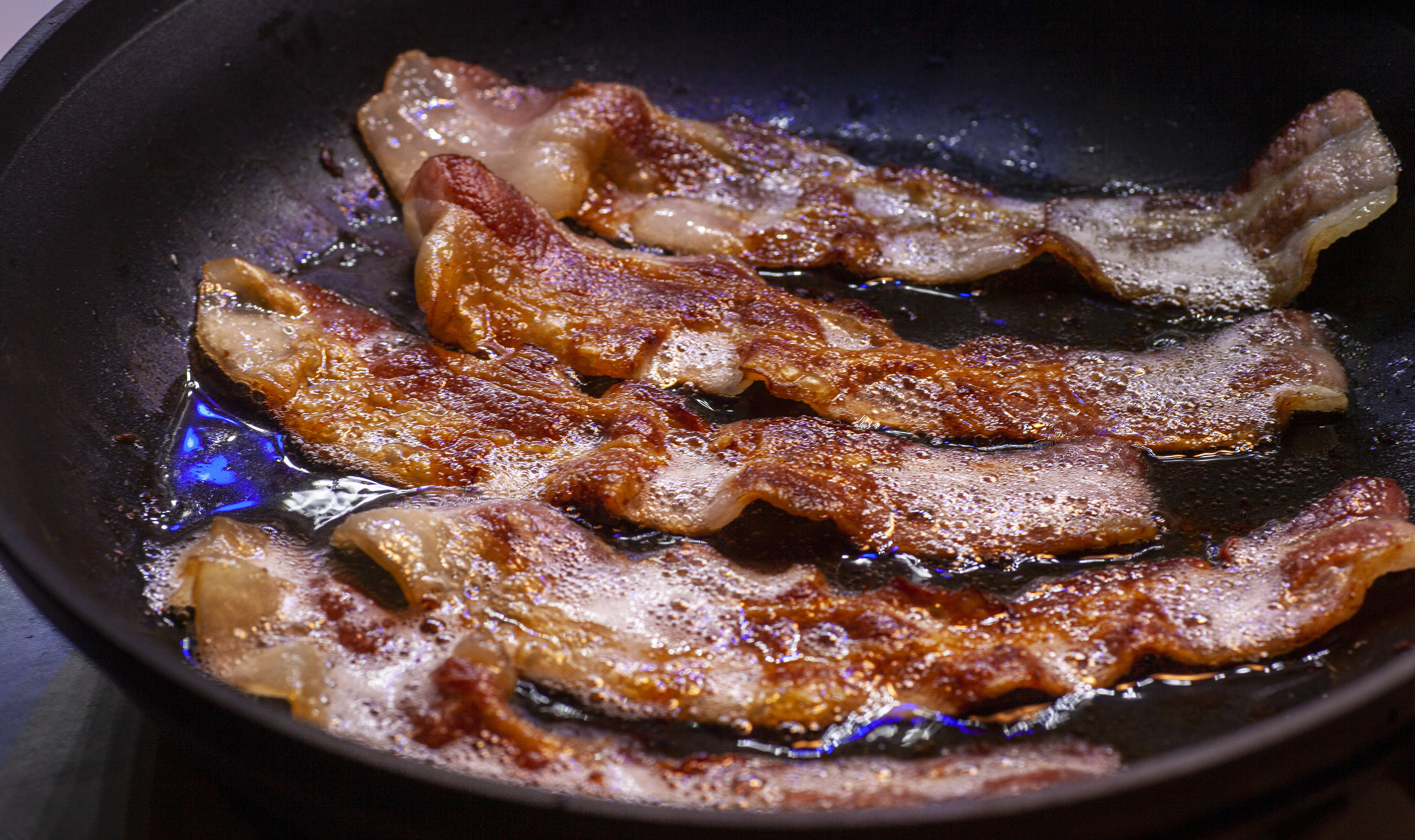 Bacon frying in a pan
